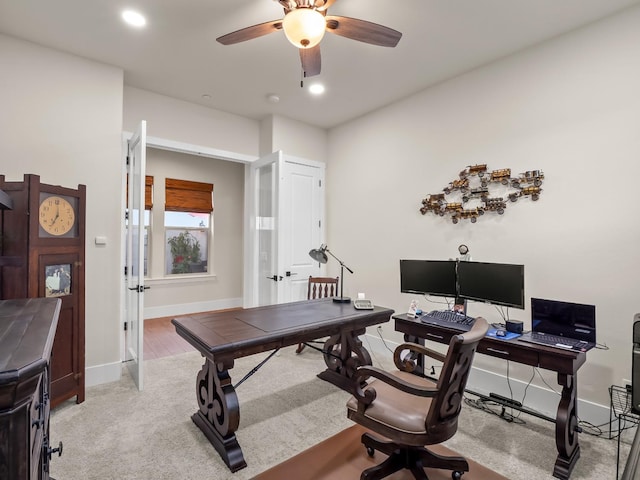 carpeted office with ceiling fan