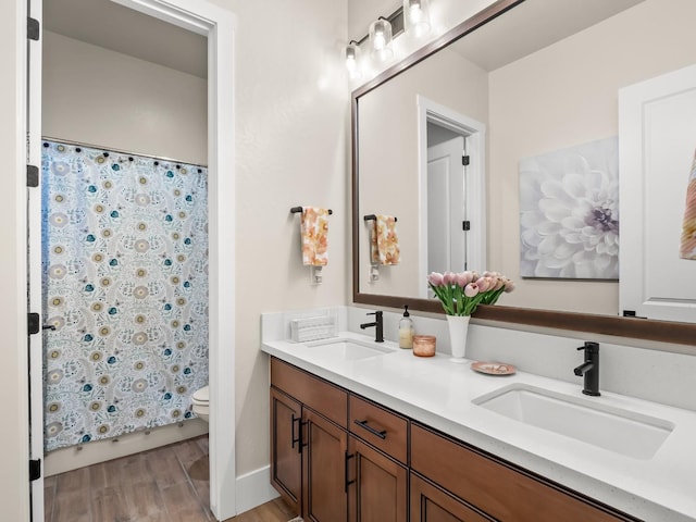 bathroom featuring hardwood / wood-style flooring, vanity, and toilet