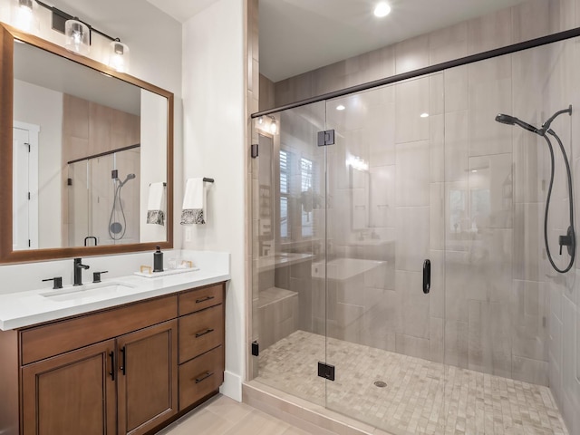 bathroom featuring tile patterned floors, vanity, and a shower with door