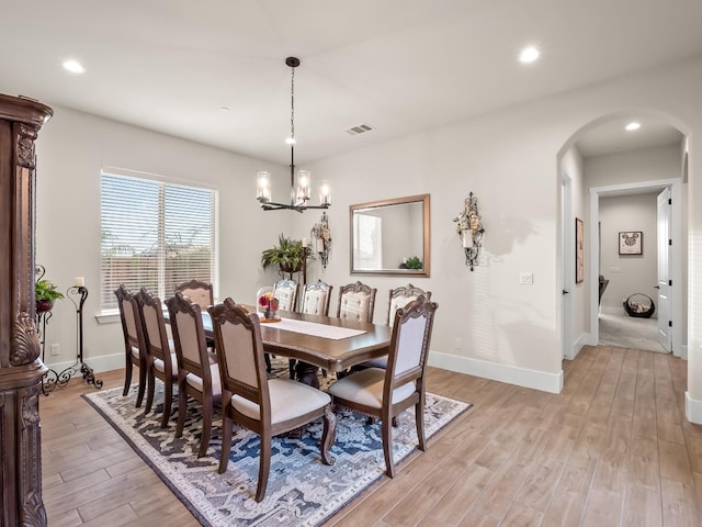 dining room featuring a notable chandelier and light hardwood / wood-style flooring