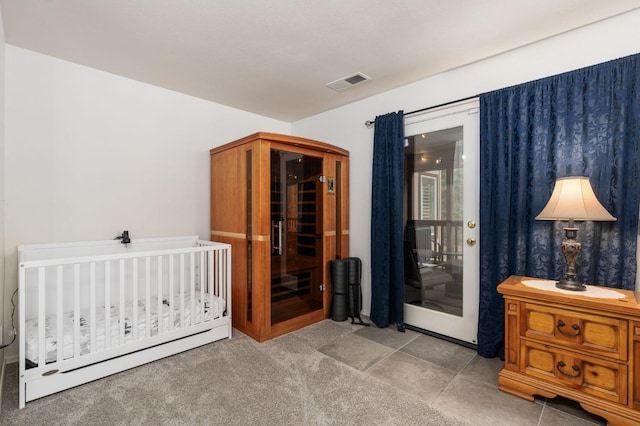 carpeted bedroom with a crib