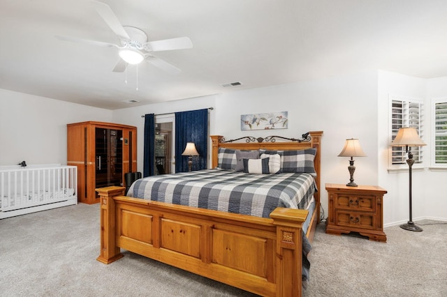 bedroom with ceiling fan and light carpet