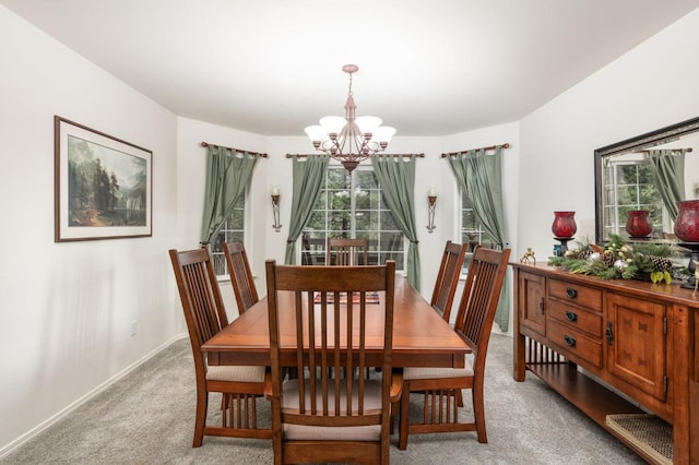 dining space featuring light carpet, an inviting chandelier, and a wealth of natural light