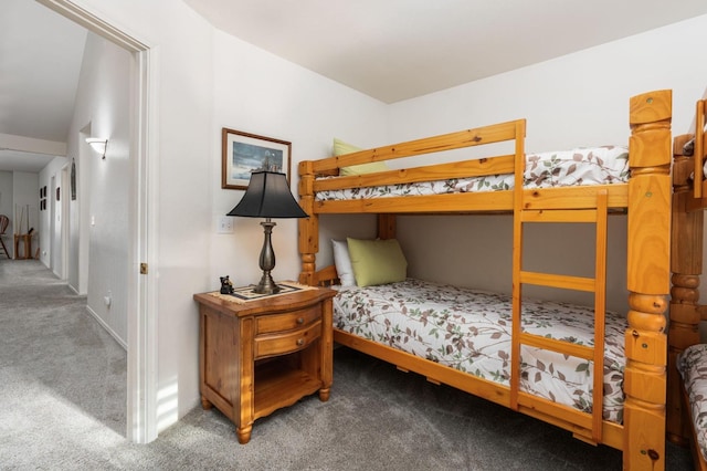 bedroom featuring lofted ceiling and carpet floors