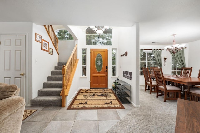 entrance foyer featuring plenty of natural light, light tile patterned floors, and a chandelier