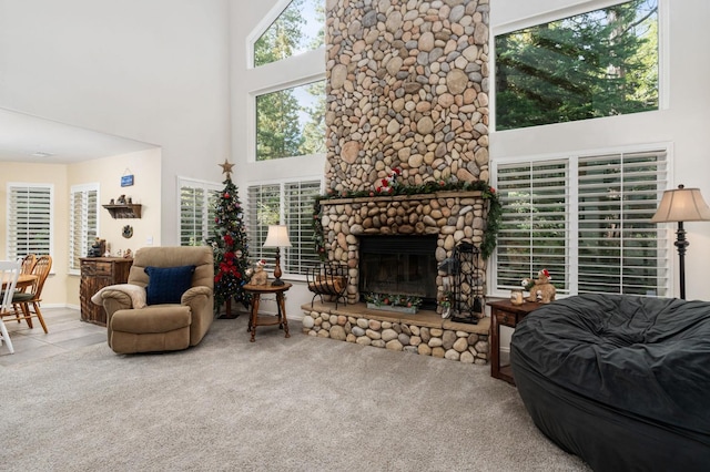 living room featuring a fireplace, carpet floors, and a high ceiling