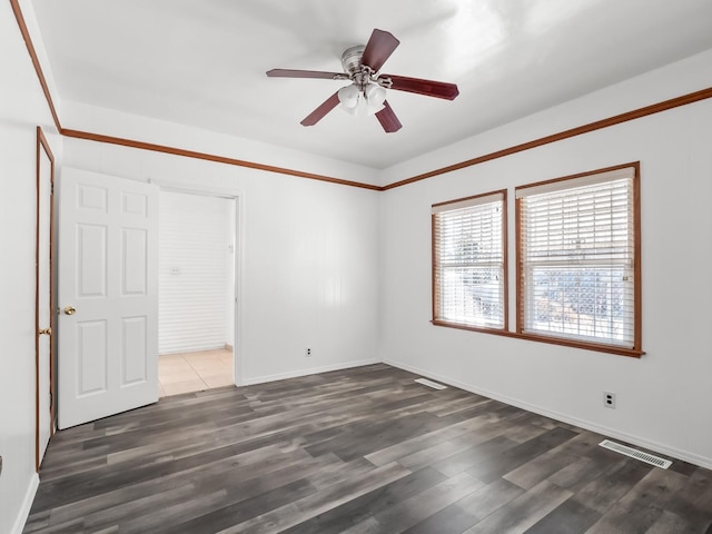 unfurnished bedroom with ceiling fan and dark hardwood / wood-style flooring