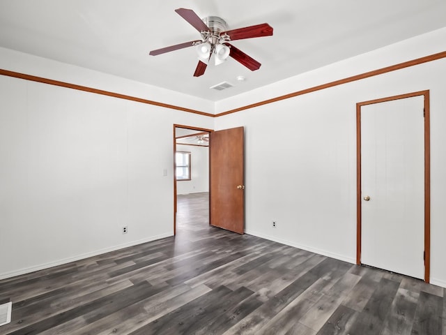 unfurnished room featuring dark hardwood / wood-style flooring and ceiling fan