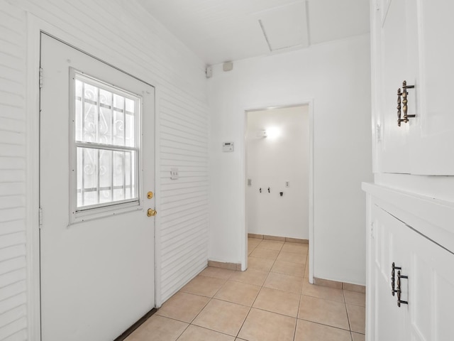 doorway with light tile patterned flooring