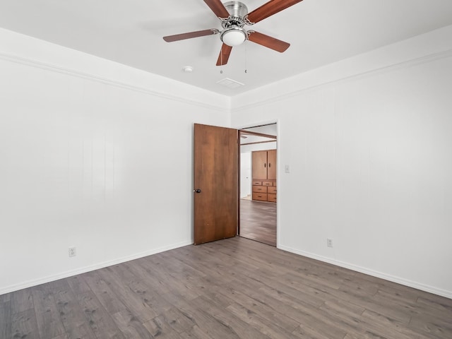 spare room with hardwood / wood-style flooring and ceiling fan