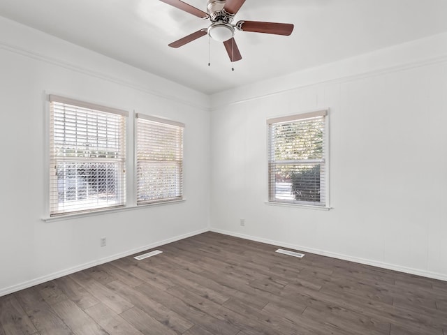 unfurnished room with ceiling fan, dark hardwood / wood-style flooring, and plenty of natural light