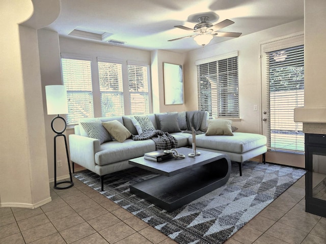 living room featuring ceiling fan and light tile patterned floors