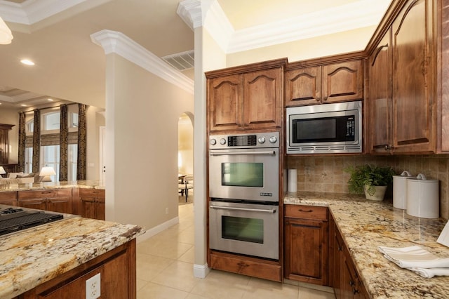 kitchen with crown molding, tasteful backsplash, and appliances with stainless steel finishes