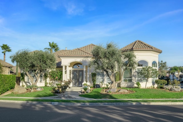 mediterranean / spanish-style house featuring a front yard