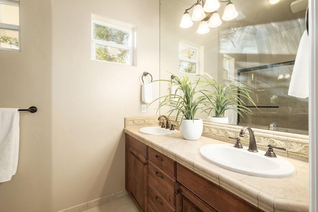 bathroom featuring vanity, a shower with shower door, and tile patterned flooring