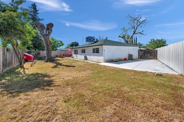 view of yard with cooling unit and a patio