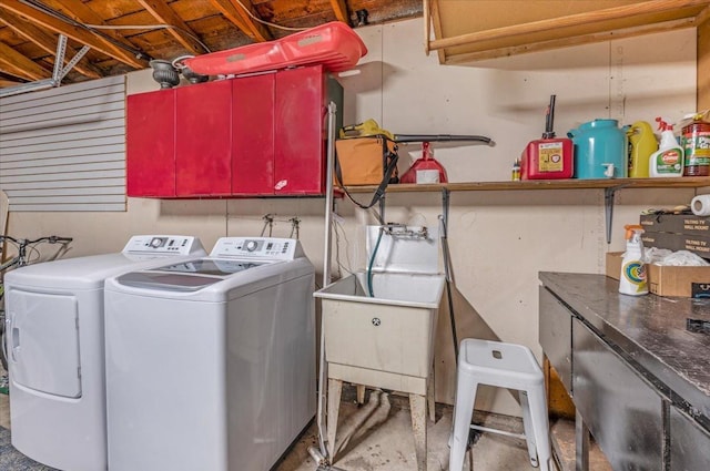 laundry room with separate washer and dryer and cabinets