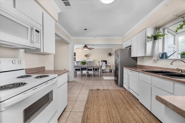 kitchen with sink, white appliances, crown molding, white cabinetry, and light tile patterned flooring