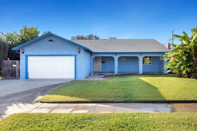 single story home featuring a garage and a front lawn