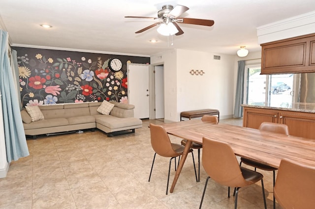 dining space with visible vents, ornamental molding, and a ceiling fan