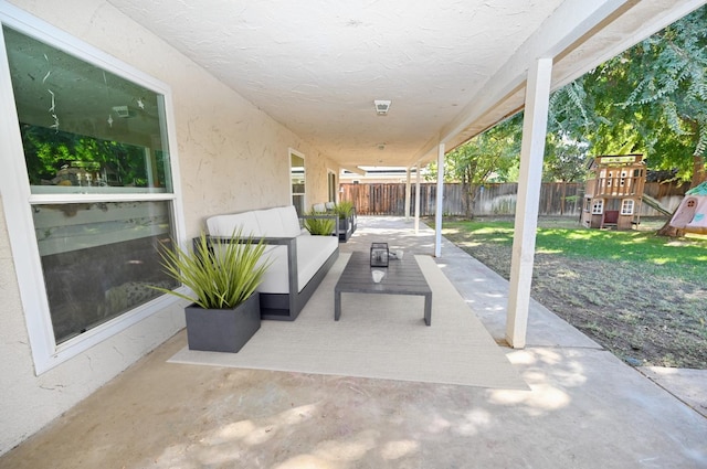 view of patio featuring outdoor lounge area, a playground, and a fenced backyard