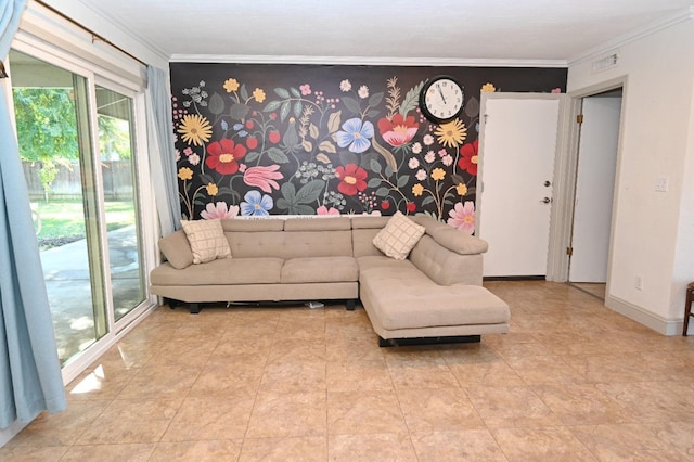 living room with an accent wall, ornamental molding, and baseboards