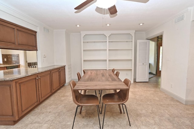 dining area featuring baseboards, visible vents, and crown molding