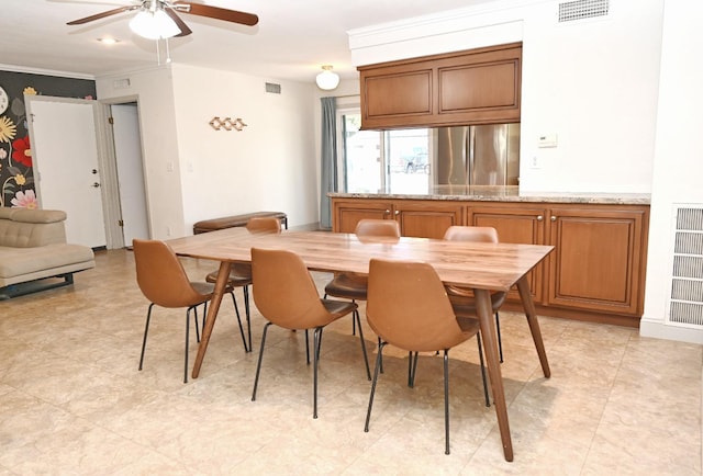 dining room featuring visible vents and a ceiling fan