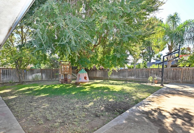 view of yard featuring a playground and a fenced backyard