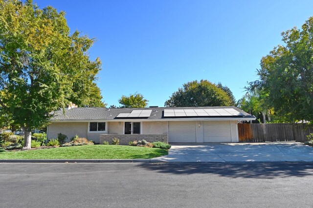 single story home featuring a front yard and a garage