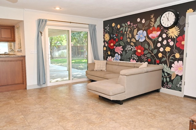 living area with ornamental molding and baseboards