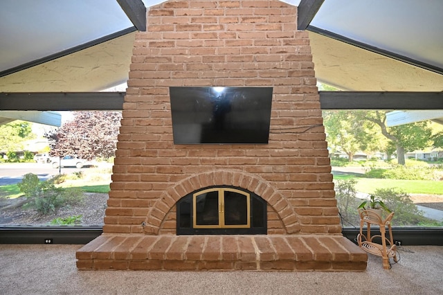 interior details with carpet and a brick fireplace