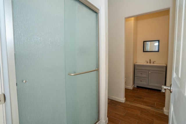 bathroom with vanity and a shower with door