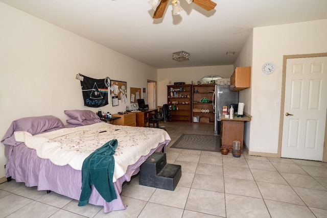 bedroom featuring light tile patterned floors, stainless steel fridge, and ceiling fan