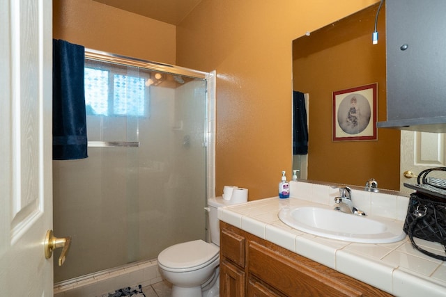 bathroom featuring vanity, a shower with shower door, tile patterned floors, and toilet