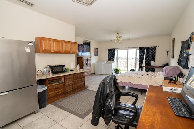 tiled bedroom with washer and clothes dryer, stainless steel refrigerator, and ceiling fan