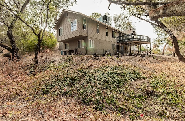 rear view of house featuring central air condition unit