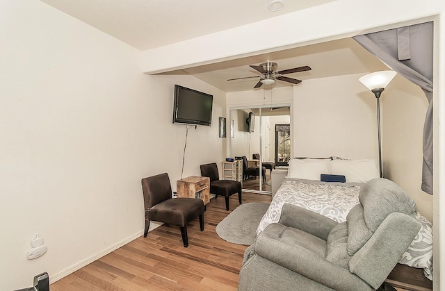 bedroom with wood-type flooring, a closet, and ceiling fan