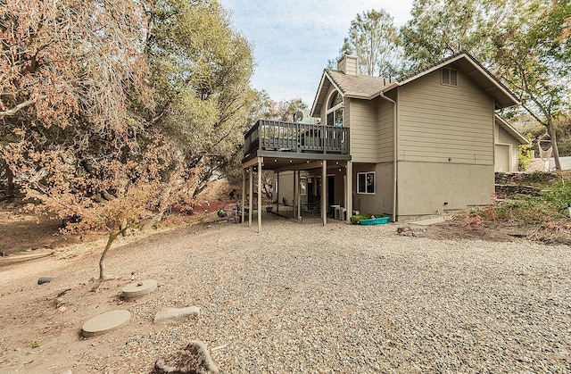 rear view of house with a wooden deck