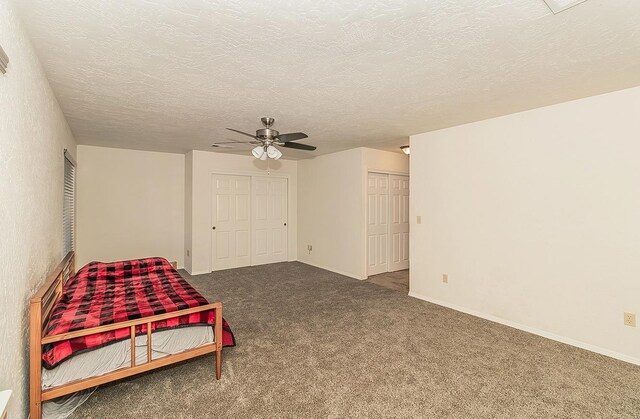 carpeted bedroom featuring a textured ceiling and ceiling fan