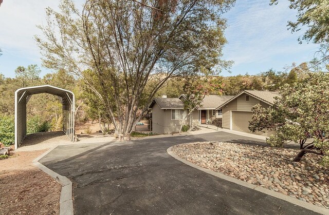 view of front of house with a carport and a garage