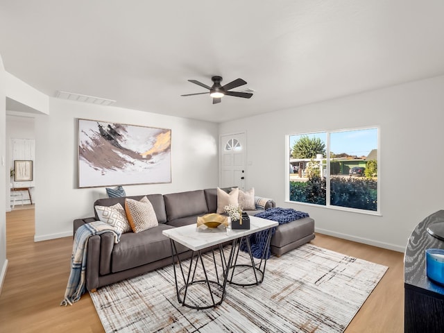 living room featuring hardwood / wood-style flooring and ceiling fan