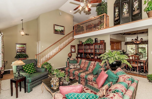 carpeted living room featuring high vaulted ceiling and ceiling fan