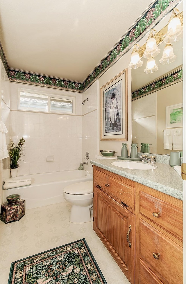 full bathroom featuring vanity, toilet, and tiled shower / bath