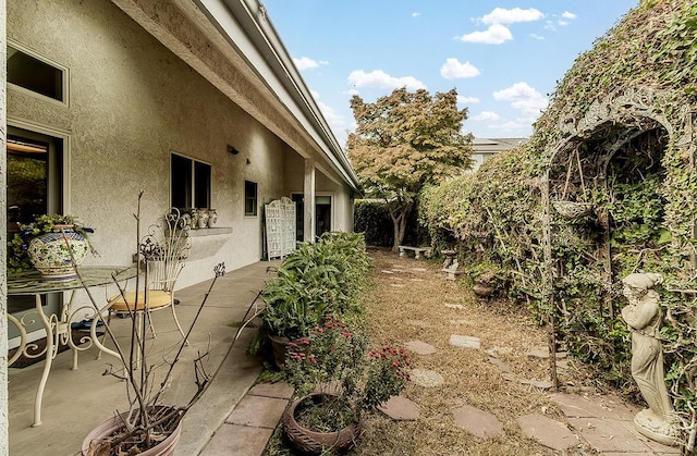 view of side of property with a patio