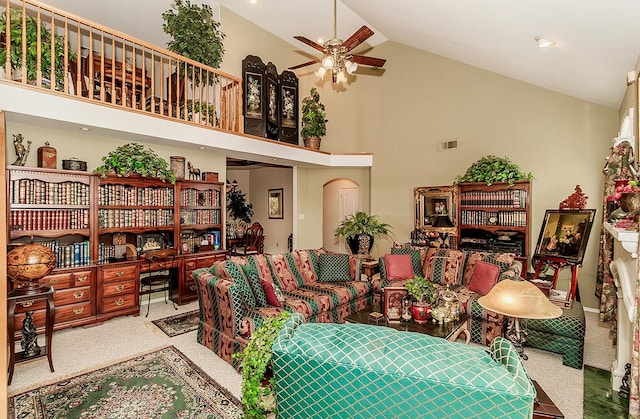 carpeted living room featuring high vaulted ceiling and ceiling fan