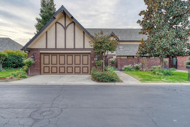 tudor house featuring a garage