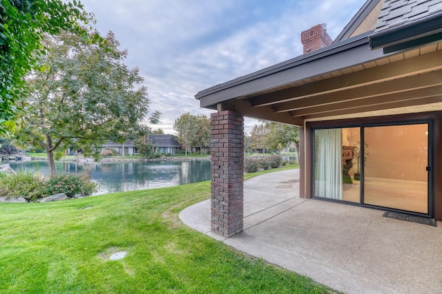 view of yard featuring a patio and a water view