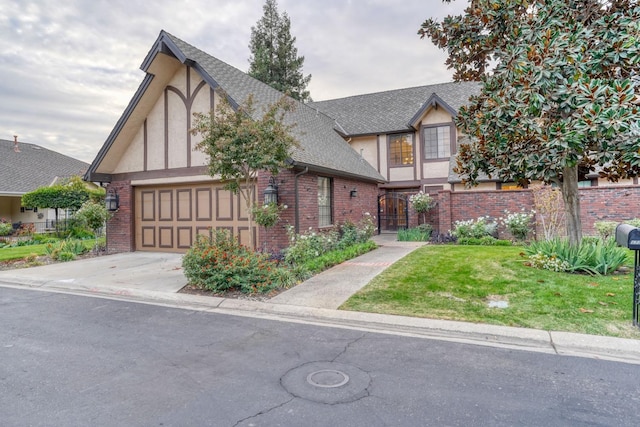 tudor home featuring a front yard