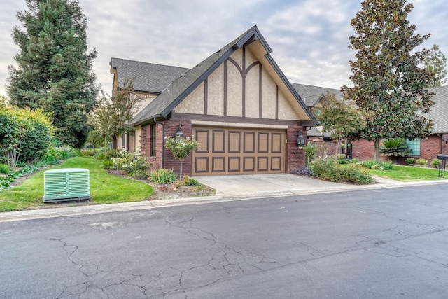 tudor house featuring a garage